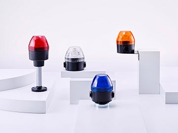 four beacons in different colors on a podest